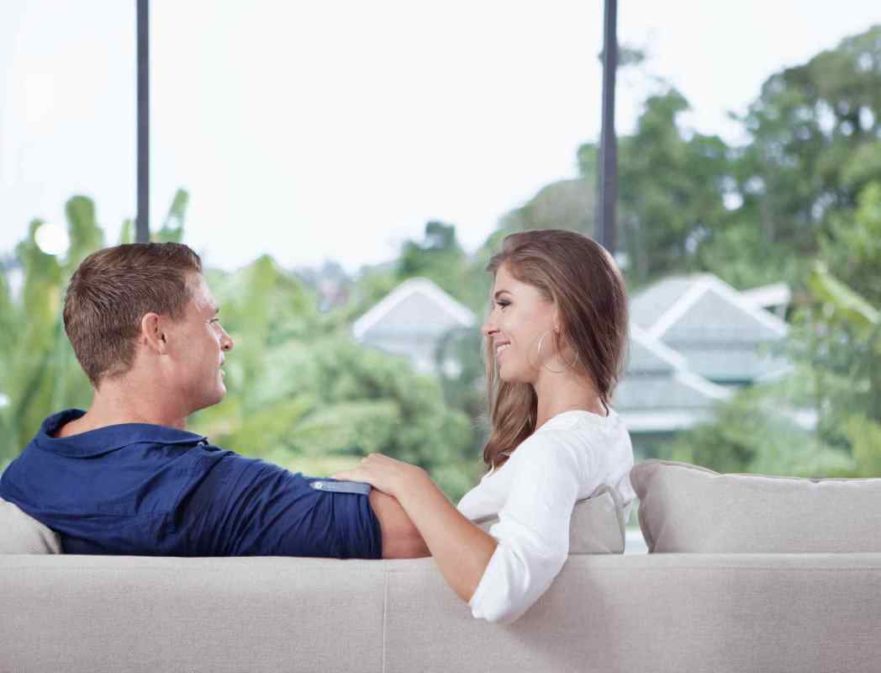 Couple in conversation on a couch - Stay Connected