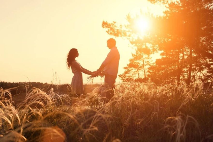 Couple holding hands in field - question that could change your marriage