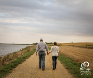 Marriage is a journey. Couple walking along a dirt road next to a lake.