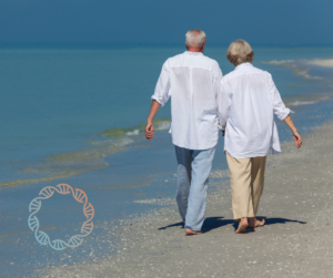 Older couple walking on beach.- close together.