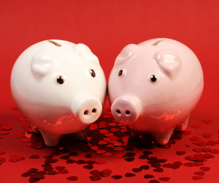 Two piggy banks surrounded by hearts. Winning at marriage.