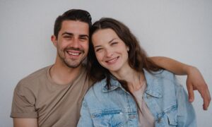 portrait of a young happy couple smiling at the camera